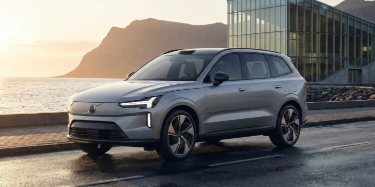 Rear three-quarter view of a light blue Volvo EX60 concept SUV with distinctive taillights, set against a screen announcing the global reveal on January 21, 2026.